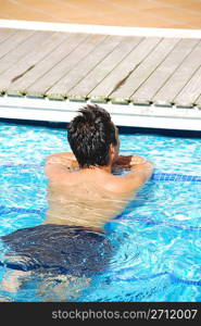 handsome man relaxing at the swimming pool