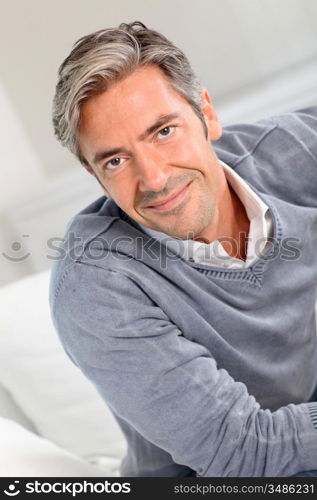 Handsome man relaxing in sofa at home