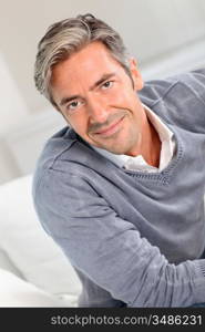 Handsome man relaxing in sofa at home