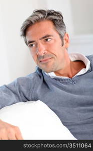 Handsome man relaxing in sofa at home