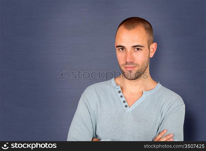 Handsome man standing on blue background