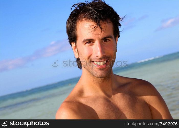 Handsome man standing on the beach