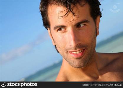 Handsome man standing on the beach