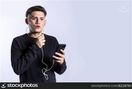 handsome man talking with headset holding cellphone , young man in glasses with earphones isolated