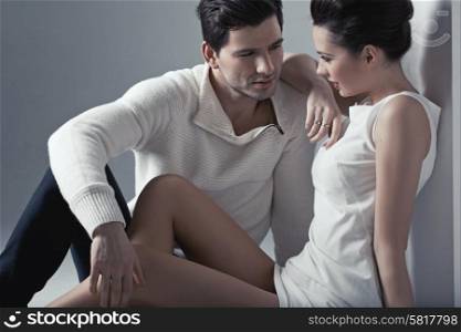 Handsome man touching soft skin of brunette woman