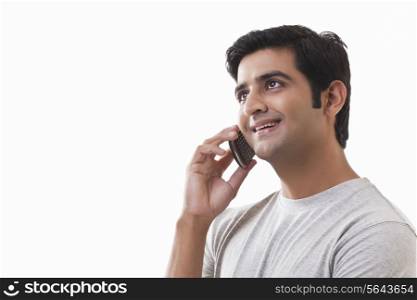 Handsome man using cell phone on white background