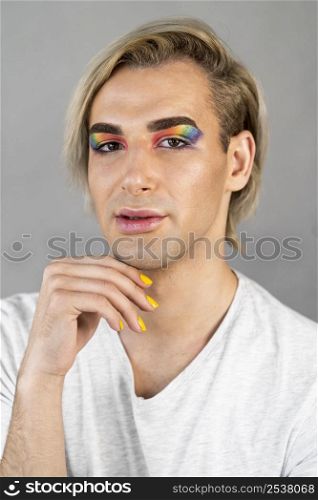 handsome man wearing make up cosmetics nail polish