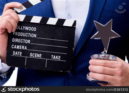 Handsome man with movie clapper isolated on white