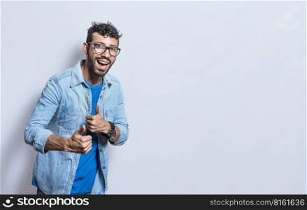 Handsome man with thumbs up doing ok, young man with thumbs up on white background, Smiling man showing ok gesture looking at camera