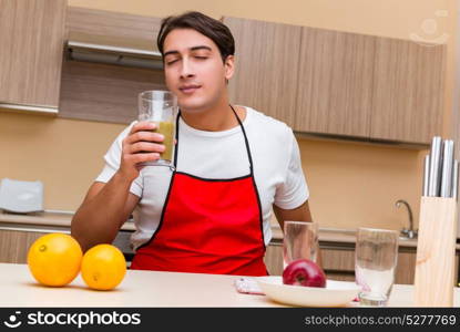 Handsome man working at the kitchen