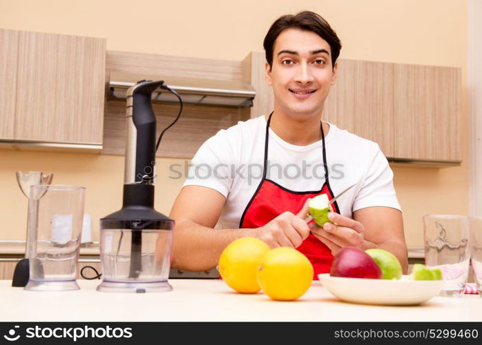 Handsome man working at the kitchen