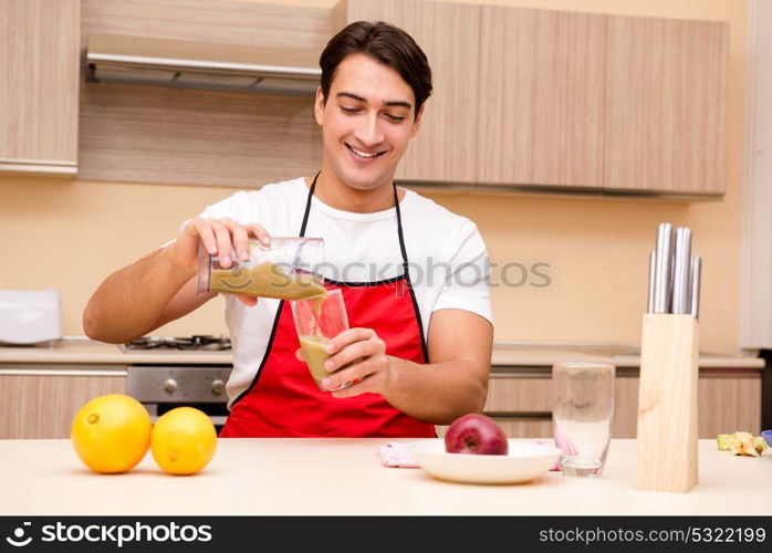 Handsome man working at the kitchen