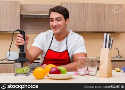 Handsome man working at the kitchen
