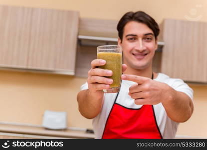 Handsome man working at the kitchen