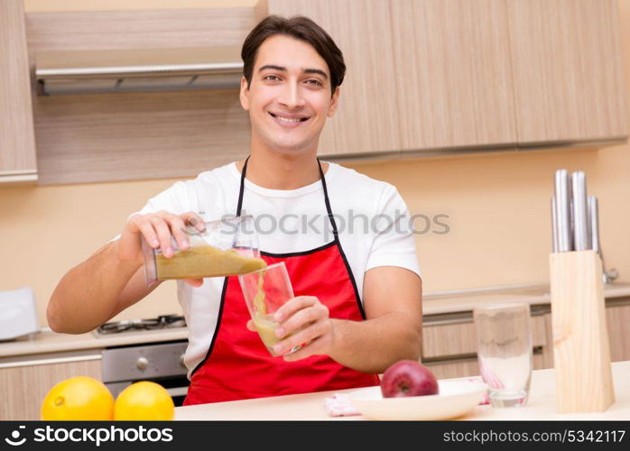 Handsome man working at the kitchen