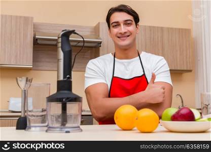 Handsome man working at the kitchen