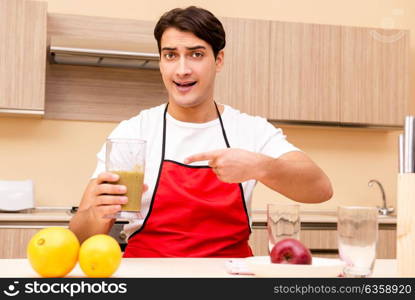 Handsome man working at the kitchen