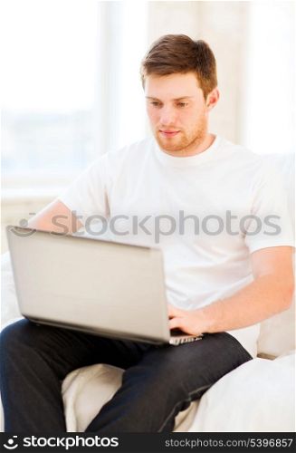 handsome man working with laptop at home