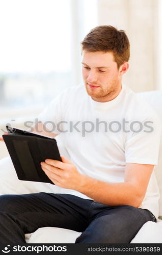 handsome man working with tablet pc at home