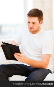 handsome man working with tablet pc at home