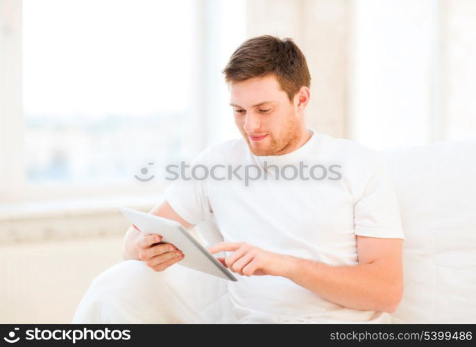 handsome man working with tablet pc at home