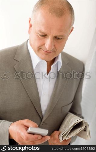 Handsome mature businessman elegant holding phone close-up professional portrait