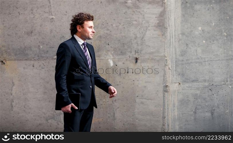 Handsome mature caucasian businessman outdoor wearing suit. Handsome mature businessman outdoor