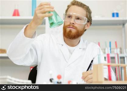 handsome mature engineer working in laboratory in the furniture factory