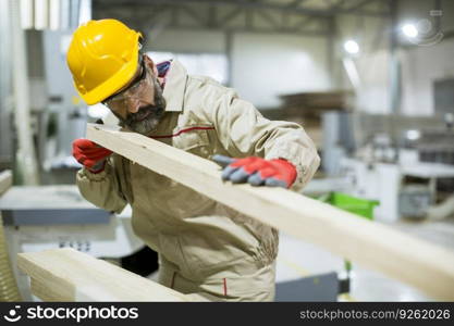 Handsome mature man working in the furniture factory