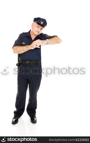 Handsome, mature policeman isolated, leaning on blank white space. Insert your sign.