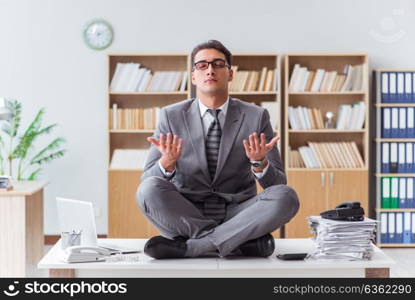 Handsome meditating on the office desk