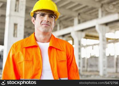 Handsome mid adult man wearing protective workwear at construction site