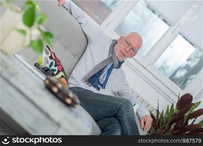 handsome middle-aged man relaxing a moment in sofa