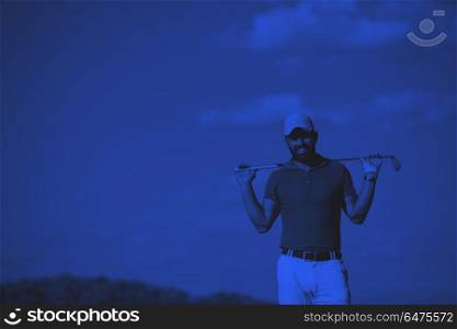 handsome middle eastern golf player portrait at course. handsome middle eastern golf player portrait at course at sunny day wearing red shirt duo tone