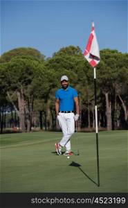 handsome middle eastern golf player portrait at course at sunny day