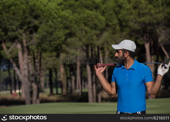 handsome middle eastern golf player portrait at course at sunny day