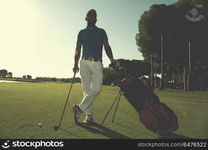 handsome middle eastern golf player portrait at course on beautiful sunset in backgeound. golf player portrait