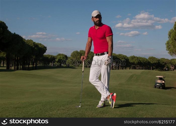 handsome middle eastern golf player portrait at course on beautiful sunset in background