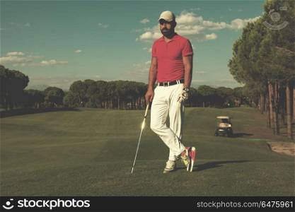 handsome middle eastern golf player portrait at course on beautiful sunset in background. golf player portrait