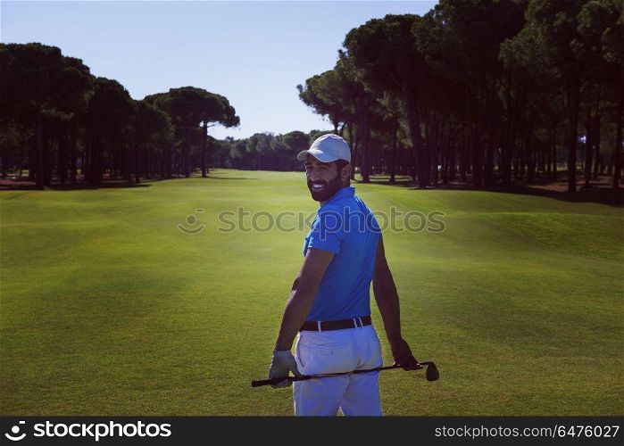 handsome middle eastern golf player portrait from back with course in background at beautiful sunny day. golf player portrait from back