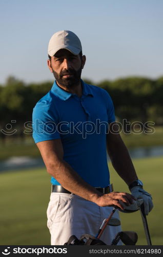 handsome middle eastern golfer portrait at golf course at sunny day