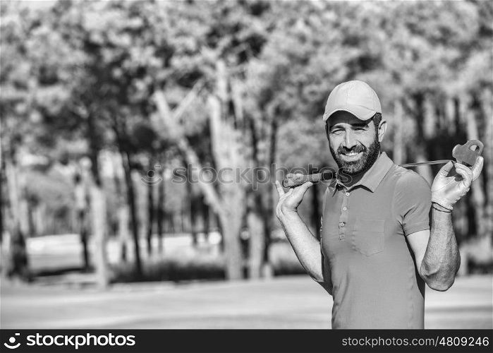 handsome middle eastern golfer portrait at golf course black and white