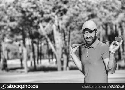 handsome middle eastern golfer portrait at golf course black and white