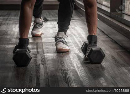Handsome muscular man doing pushups on dumbbell in gym or fitness club. Healthy lifestyle bodybuilding, Athlete builder muscles lifestyle.