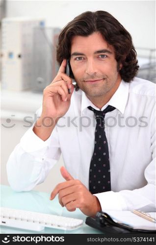 Handsome office worker making a phone call