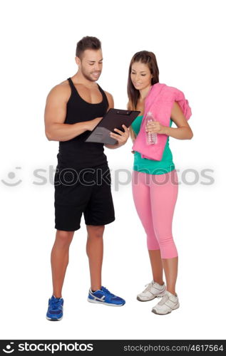 Handsome personal trainer with a attractive girl isolated on a white background