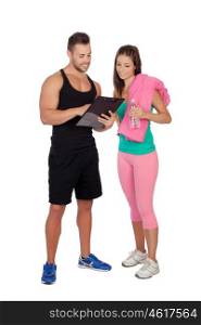 Handsome personal trainer with a attractive girl isolated on a white background