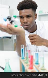handsome researcher mixing with color test tube
