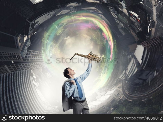 Handsome saxophonist. Young man in suit with saxophone in hands