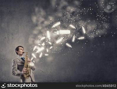 Handsome saxophonist. Young man playing saxophone and lightbulbs coming out